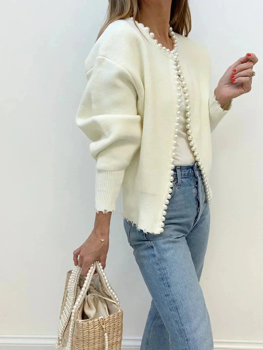 Feminine long sleeve pearl trim cardigan for women. Sophisticated round neck top, ideal for elegant layering.
