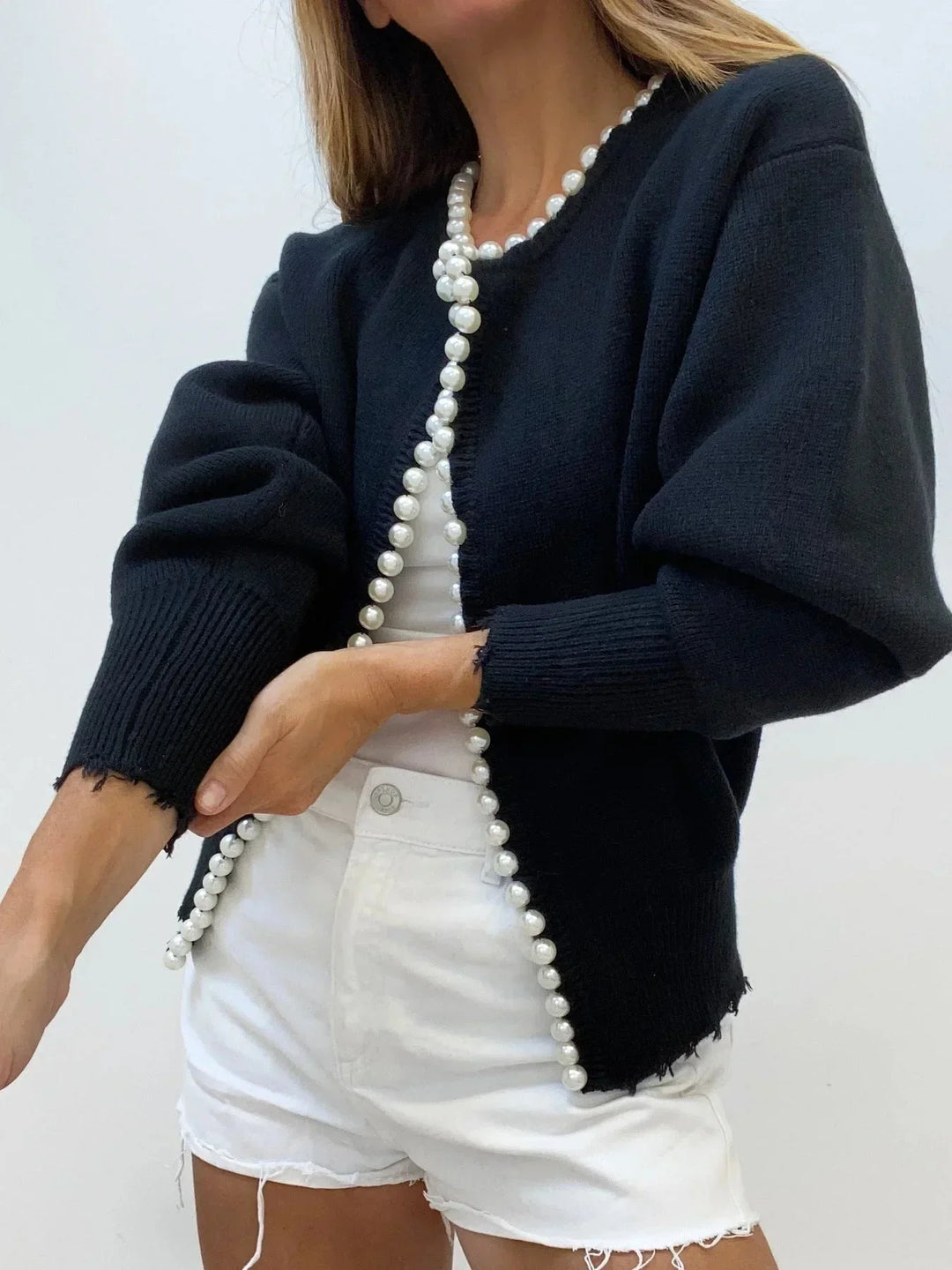 Women's elegant pearl trim cardigan. A sophisticated top perfect for workwear, brunch outfits, or travel style.