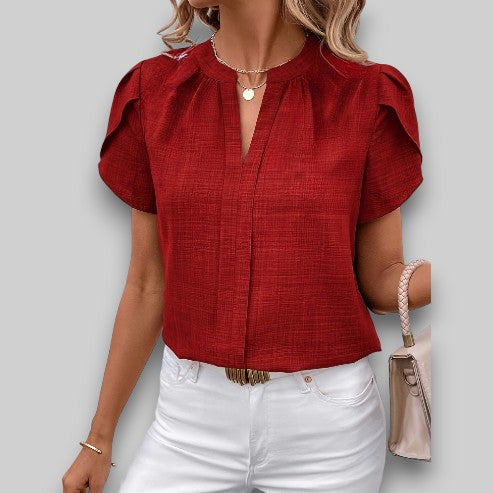 Chic women's blouse featuring elegant petal sleeves & a pleated neckline, a stylish & versatile short sleeve top.