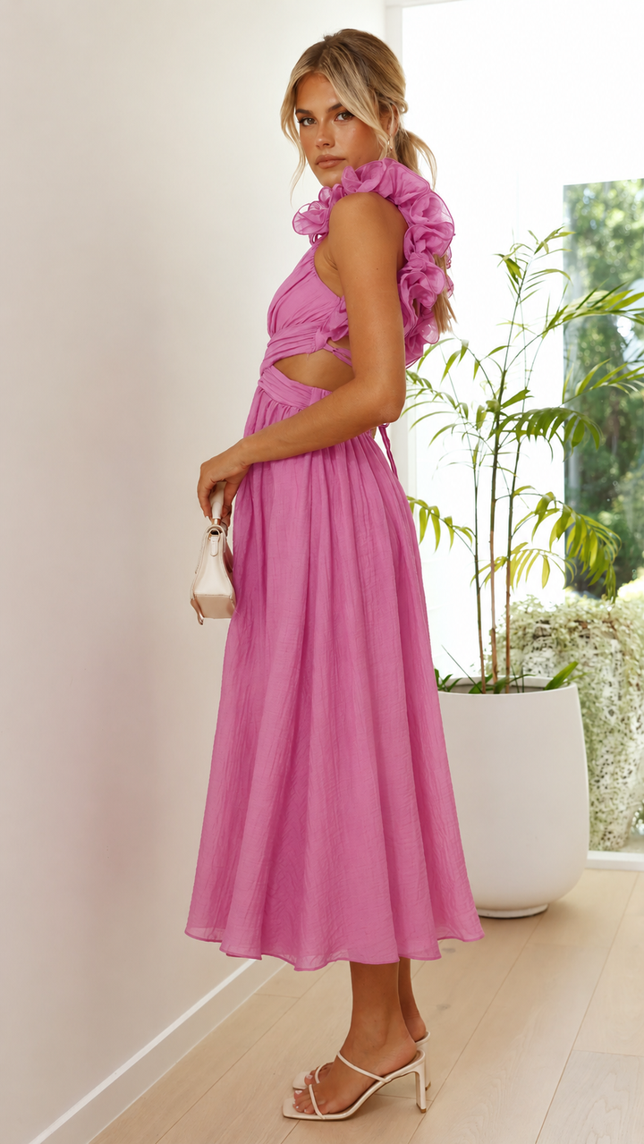 Chic women's pink maxi wedding guest dress featuring romantic ruffles and a trendy lace-up back.