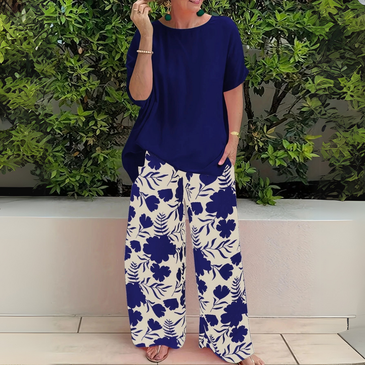 Stylish women's plus size floral two-piece outfit with elegant top and comfortable wide-leg pants.
