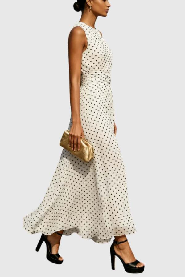 Close-up of the stylish halter neckline and keyhole detail on a women's polka dot maxi dress bodice.