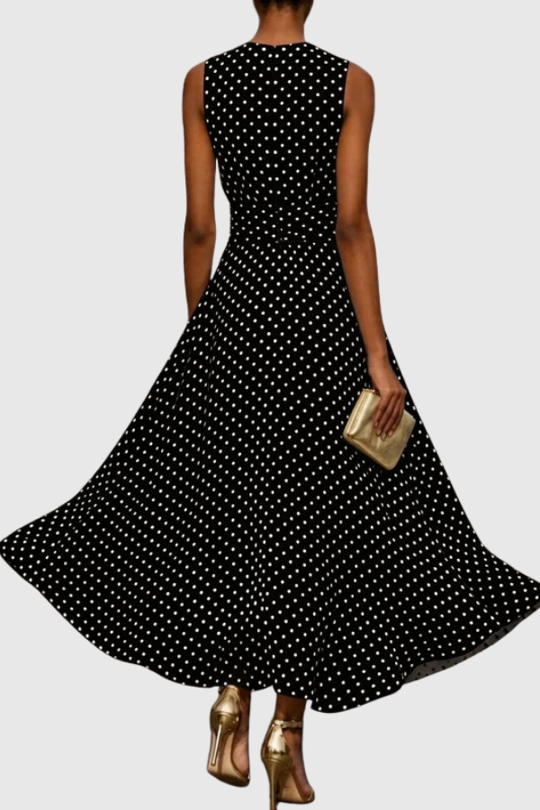 Flowy ruffle hem of an elegant polka dot maxi dress, showcasing the soft fabric and summer design.