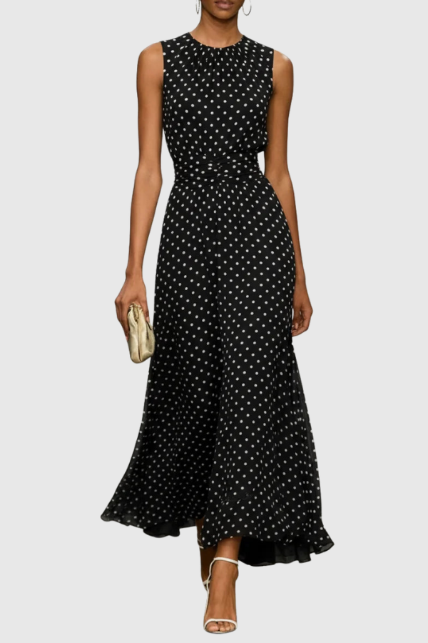Woman enjoying vacation in a sophisticated polka dot halter maxi dress, ideal for summer elegance.