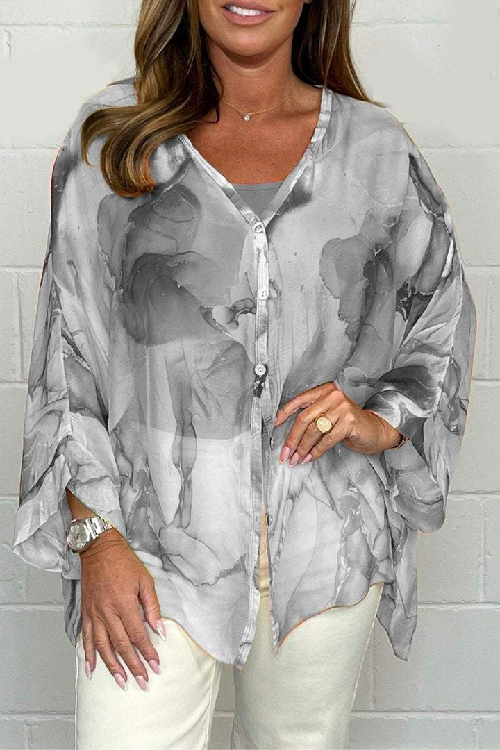 Elegant women's printed blouse, long sleeve, flowy, perfect for office chic or casual spring/summer style.
