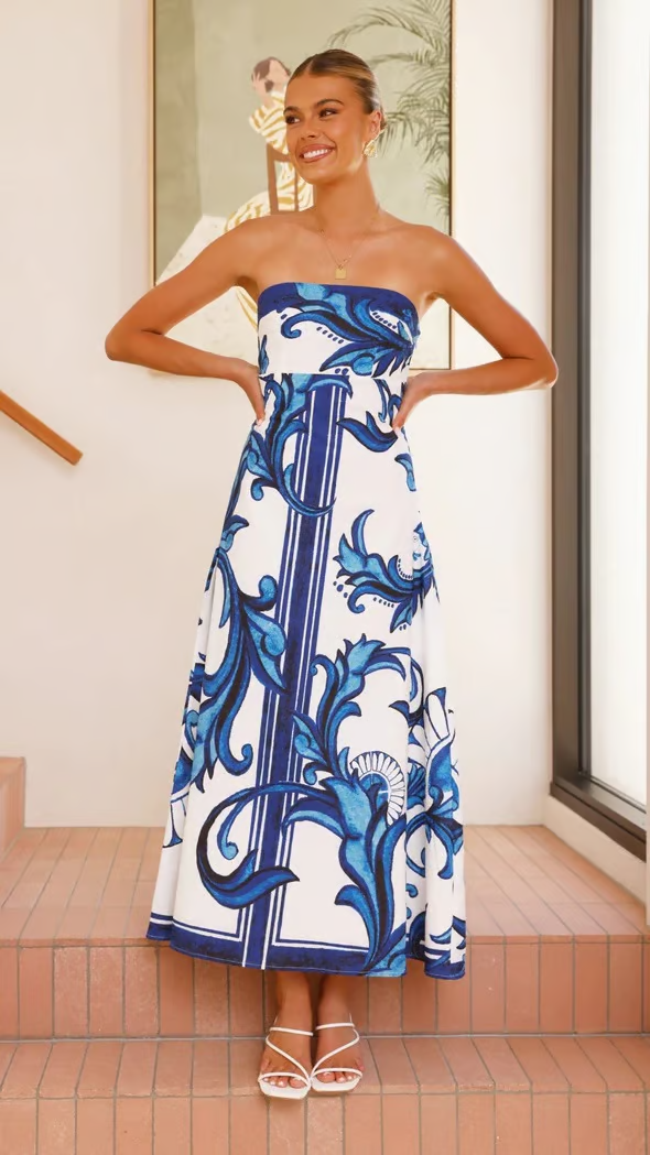 Elegant women's printed flowy dress with short sleeves, perfect for summer casual wear or a wedding guest.