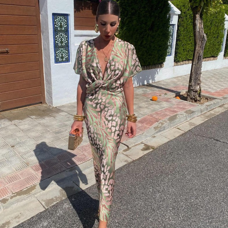 Elegant women's printed maxi wedding guest dress with a chic twist detail, perfect for special occasions.