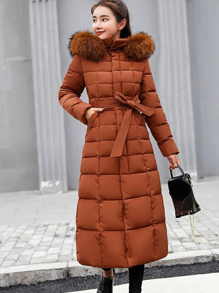 Close-up of a women's elegant puffer jacket, showing warm down insulation, stylish quilting, and durable zipper.