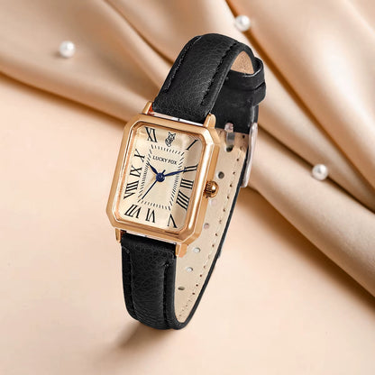 Women's gold-tone rectangle watch with white dial, black leather strap and precise quartz movement.