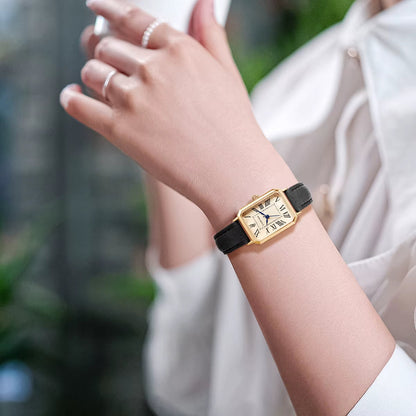 Elegant women's rectangle watch featuring gold-tone case, Roman numerals and a slim leather strap.