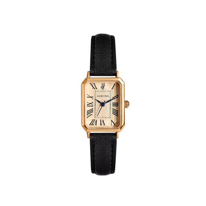 Close-up of women's elegant gold-tone rectangle quartz watch dial with Roman numeral markers.