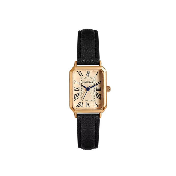 Close-up of women's elegant gold-tone rectangle quartz watch dial with Roman numeral markers.