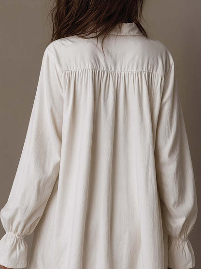 Chic white long-sleeve retro-style dress for women, featuring a unique irregular hem and elegant design.