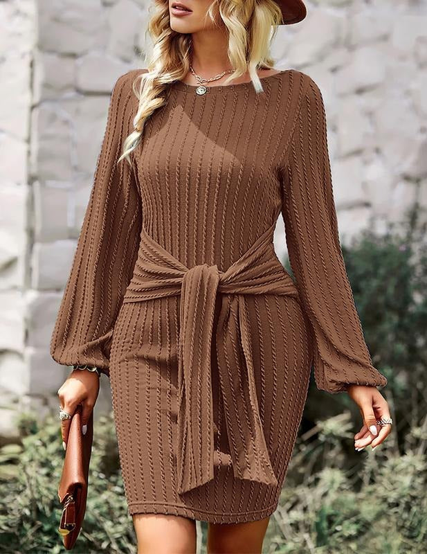 Close-up of a stylish women's ribbed midi dress, highlighting the elegant texture & adjustable waist tie detail.