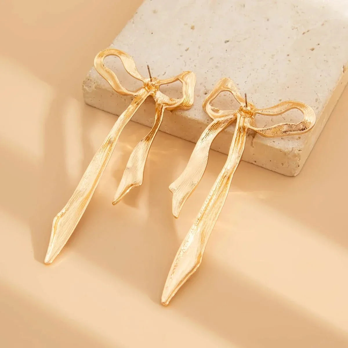 Chic women's bow earrings. Elegant ribbon design, perfect dainty jewelry for daily wear or as a thoughtful gift for her.