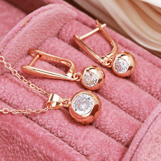 Elegant women's rose gold zircon orb necklace and matching earrings jewelry set.