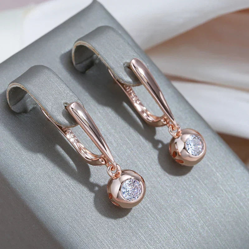 Delicate rose gold zircon orb pendant necklace, part of a women's elegant jewelry set.