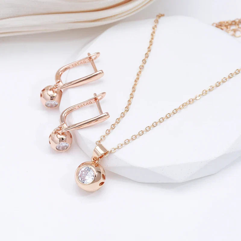 Rose gold minimalist jewelry set for women, featuring sparkling zircon orb necklace and earrings.