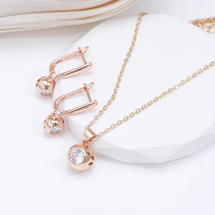 Rose gold minimalist jewelry set for women, featuring sparkling zircon orb necklace and earrings.