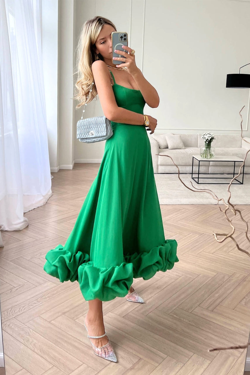 Formal women's wedding guest maxi dress featuring a graceful ruffle hem and scoop neckline.