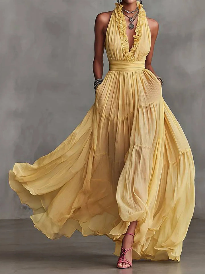 Elegant women's ruffle trim plunging maxi evening dress, perfect for formal events & wedding guests. Features a pleated skirt.