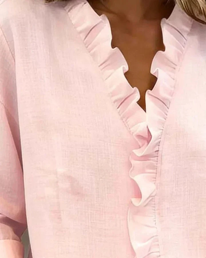Flat lay of women's ruffled V-neck long sleeve blouse, an elegant and versatile top for workwear or casual chic.