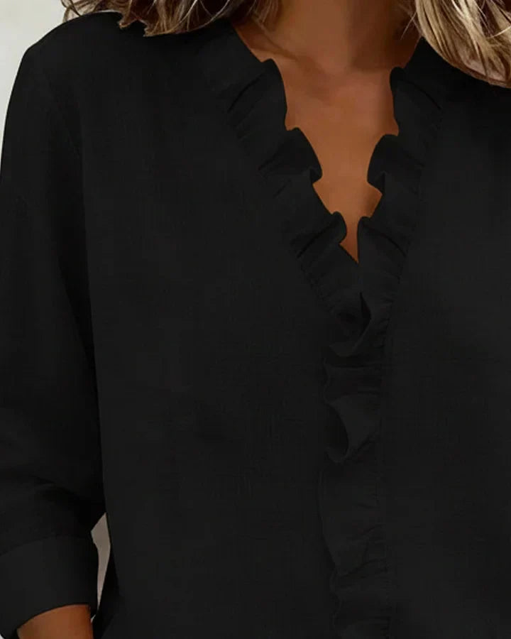 Full length shot of women's elegant ruffled V-neck long sleeve blouse, a versatile top for spring & fall fashion.