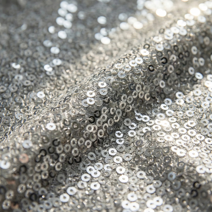 Close-up of a women's shimmer V-neck top with long sleeves, showcasing the fabric texture.