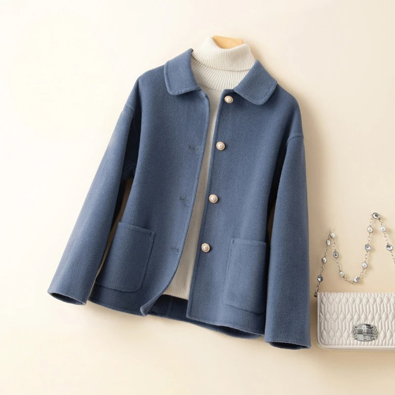 Chic blue women's short winter coat. Elegant and warm outerwear, a classic fashion piece for autumn & winter.