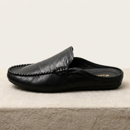 Modern women's open-toe mules. Elegant slip-on flat loafers for summer comfort and effortless casual style.