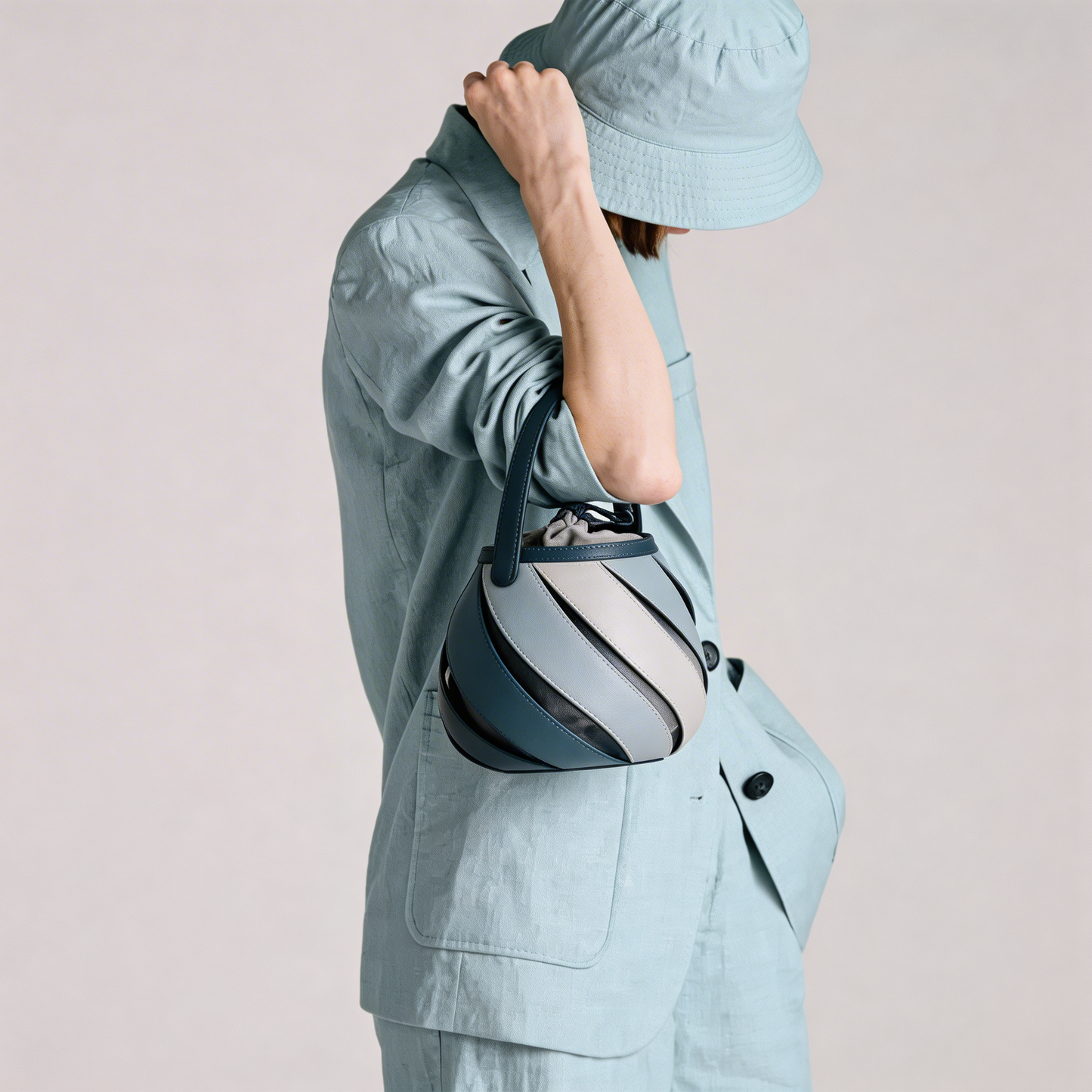 Modern chic women's spiral cage bucket bag, unique elegant top-handle handbag, fashion accessory.
