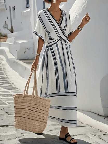 Women's elegant striped wrap maxi dress with flowy fabric, V-neck, short sleeves. Ideal for summer & travel.