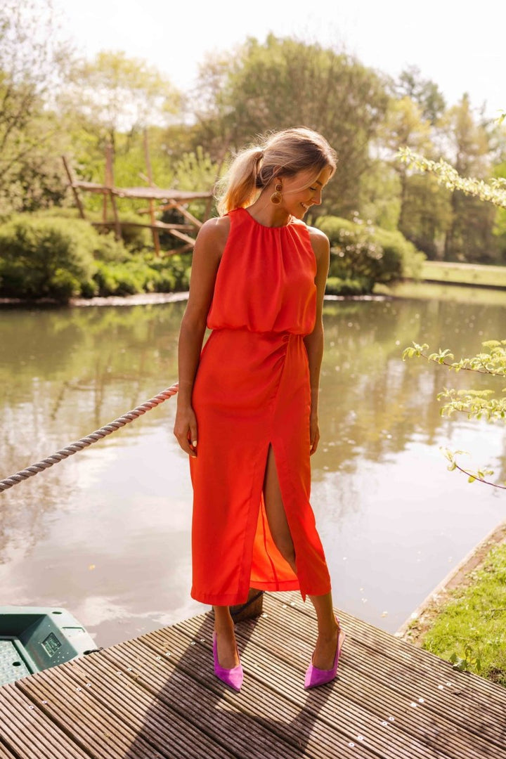 Front view of a women's elegant flowing summer midi dress with thin adjustable straps, vacation-ready.