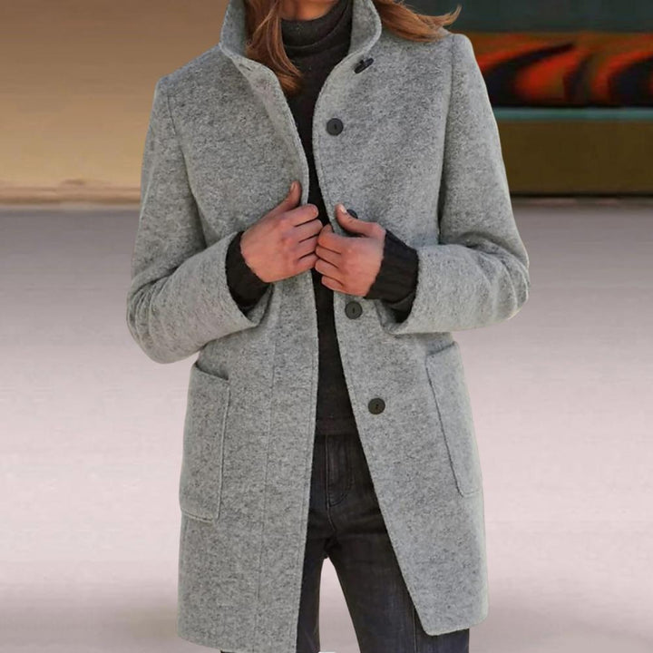 Professional women's mid-length tailored coat. Elegant button closure & sophisticated design for work or casual wear.