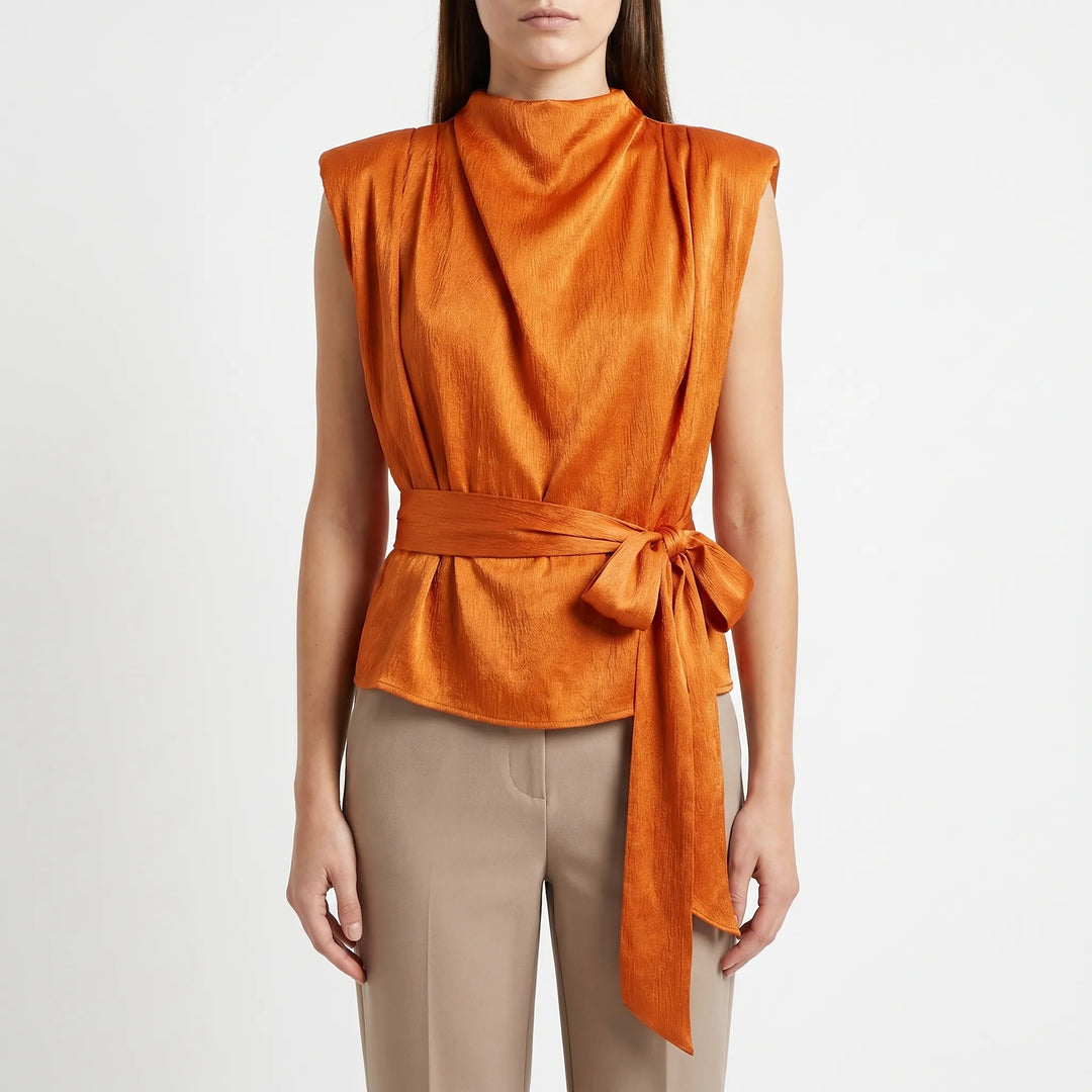 Back view of an elegant women's textured sleeveless blouse, showcasing the adjustable tie-waist for a custom fit.