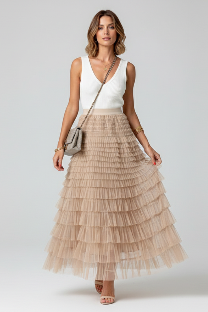 Flowy tiered midi skirt featuring delicate ruffles and an elastic high waist, ideal for feminine style.