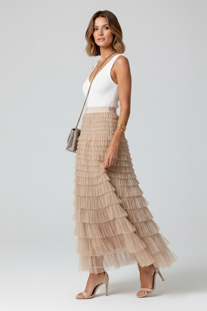 Romantic flowy tiered midi skirt with an elastic high waist, designed for comfortable, elegant fashion.