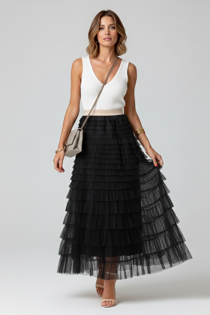 Feminine high-waist tiered midi skirt with graceful ruffle details, offering a versatile and romantic appeal.