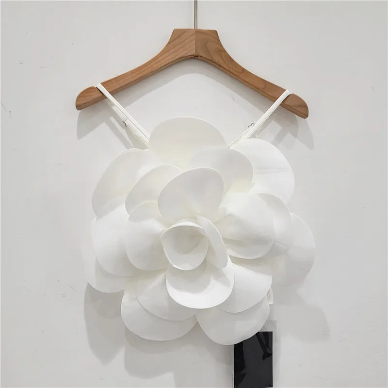 Bold statement women's top featuring luxurious 3D floral embellishments. Perfect for elegant spring fashion.