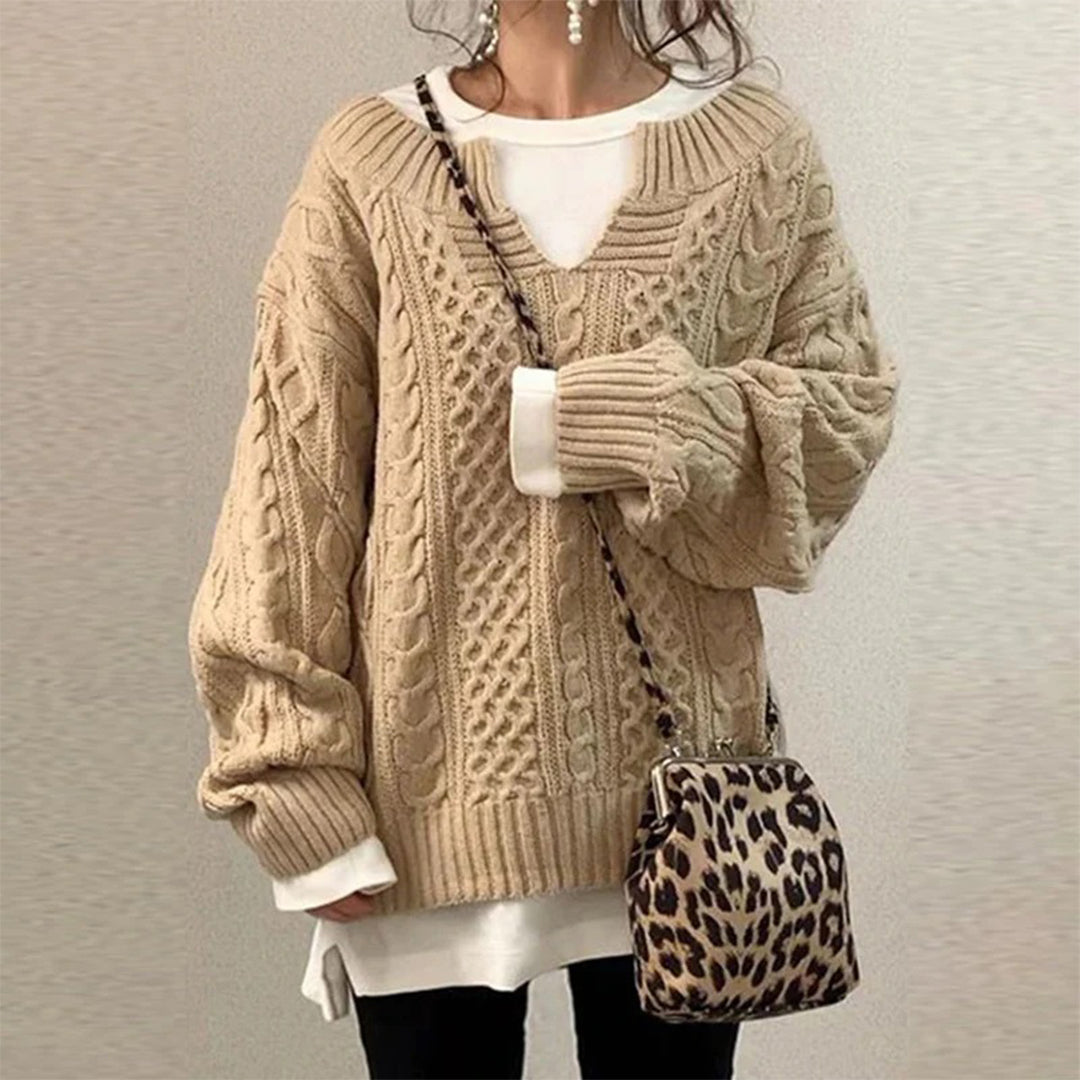 Women's elegant twisted knit winter sweater, a warm long-sleeve top for cozy and stylish cold weather.