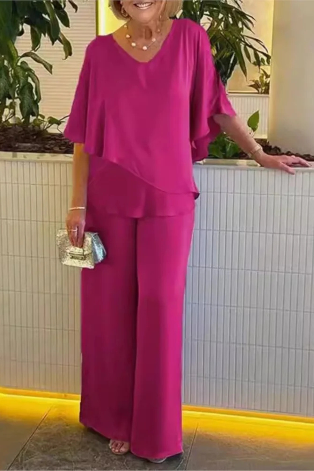 Contemporary women's outfit: V-neck batwing top and wide-leg trousers two-piece set. Sophisticated style.