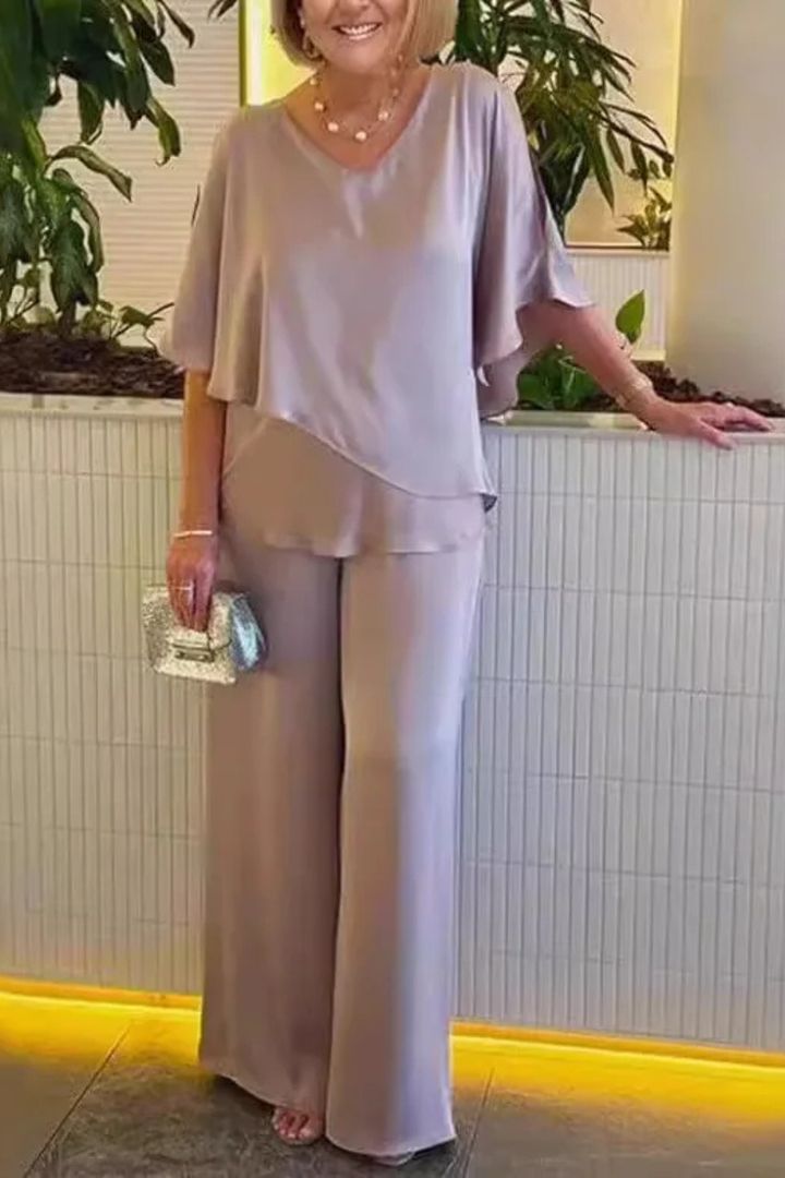 Women's sophisticated outfit: Batwing sleeve V-neck top paired with elegant wide-leg trousers.