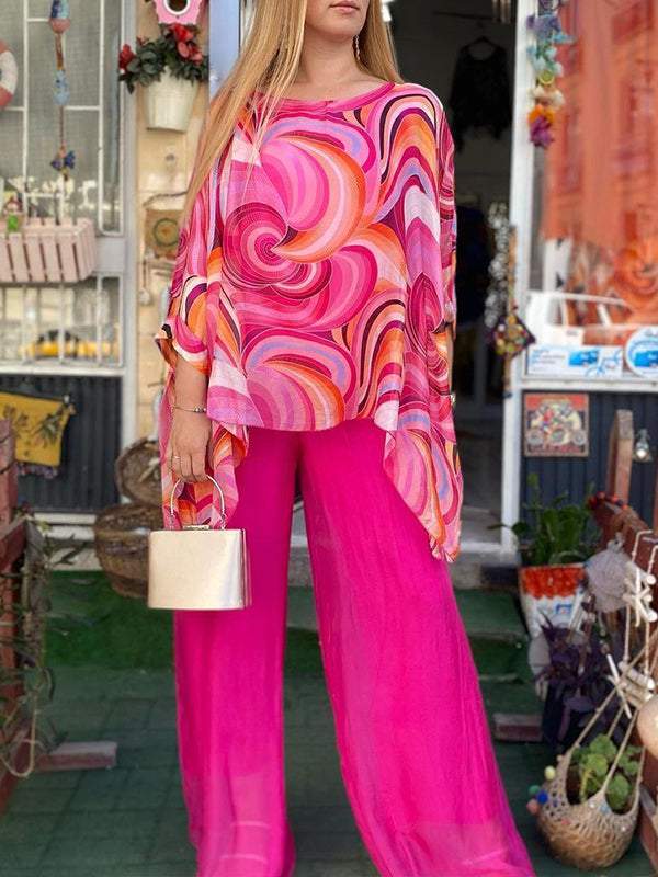 Statement women's two-piece set with vibrant artistic swirl print, flowy top & wide leg pants.