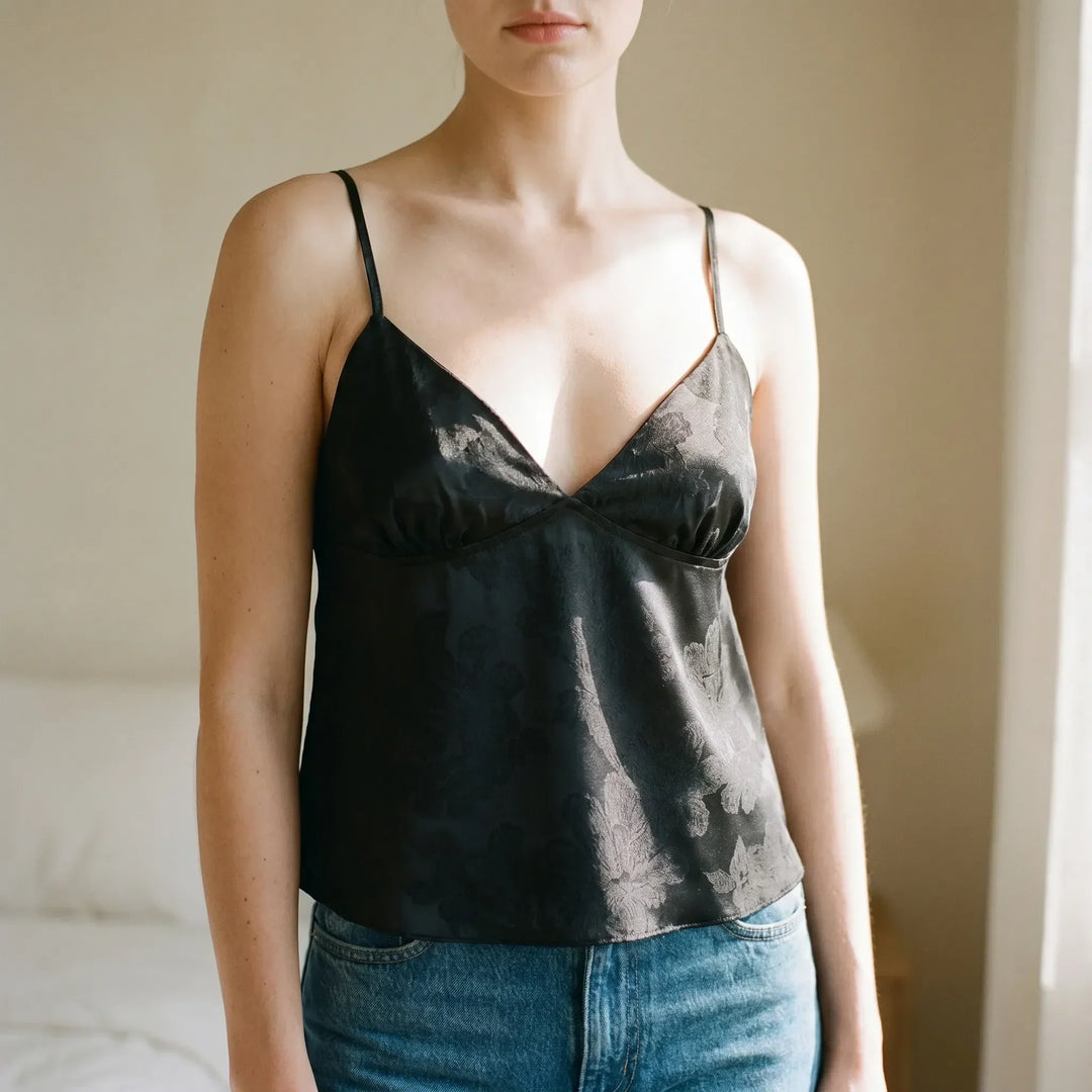 Elegant women's V-neck cami top with spaghetti straps. Features a chic floral jacquard pattern, perfect for day to night wear.