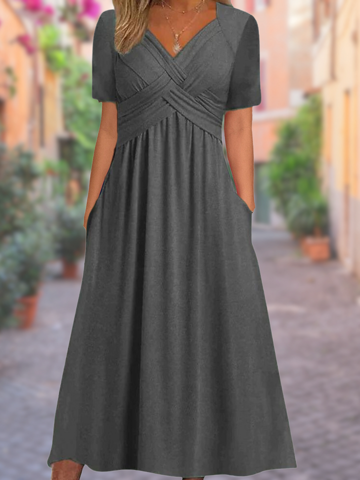 Women's casual yet elegant V-neck midi dress with stylish crisscross detail, great for summer fashion.