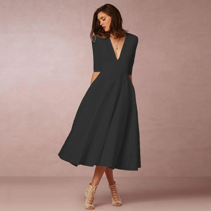 Women's elegant black V-neck elbow-sleeve midi dress, perfect for sophisticated workwear.