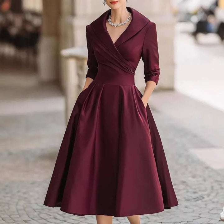 Stylish women's three-quarter sleeve V-neck midi dress featuring practical pockets and elegant design.