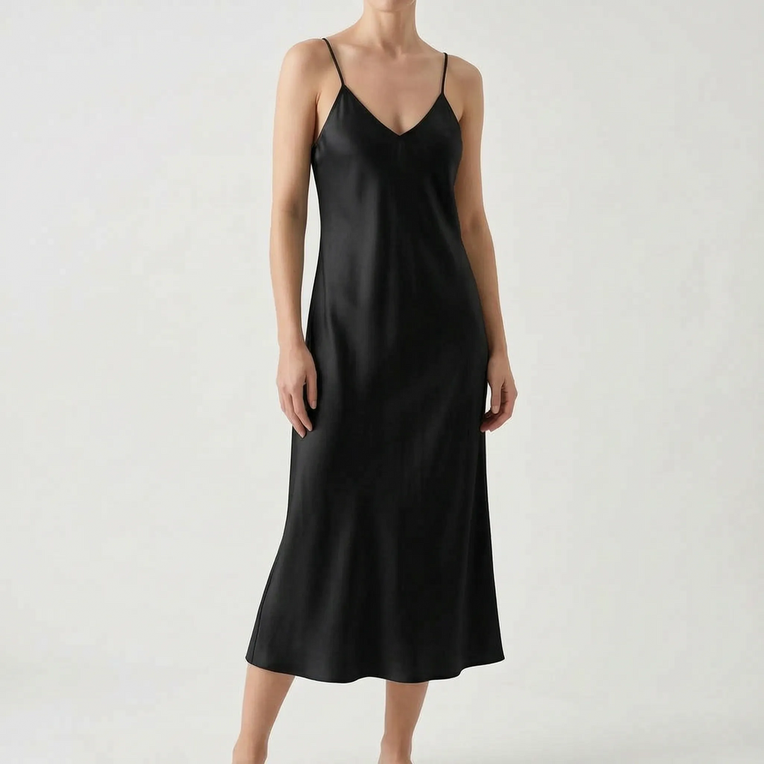 Fashionable women's slip dress with a V-neck and spaghetti straps. Elegant midi, perfect for parties or casual looks.