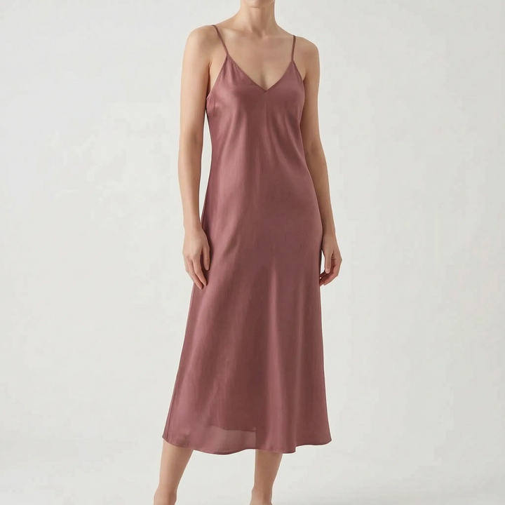 Women's elegant V-neck slip dress with thin spaghetti straps, a versatile midi for day to night style.