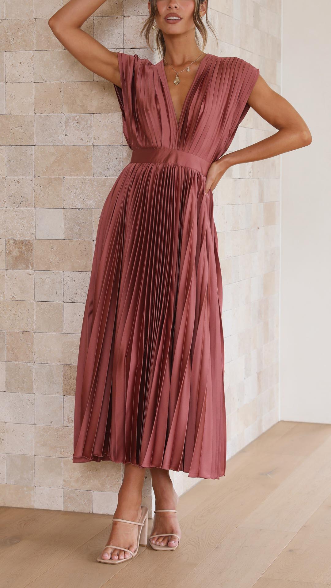 Women's formal sleeveless pleated maxi dress with a sophisticated V-neck design.